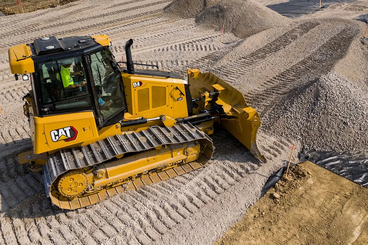 CAT D4 dozer working a prepared gravel pad on a Minnesota job site